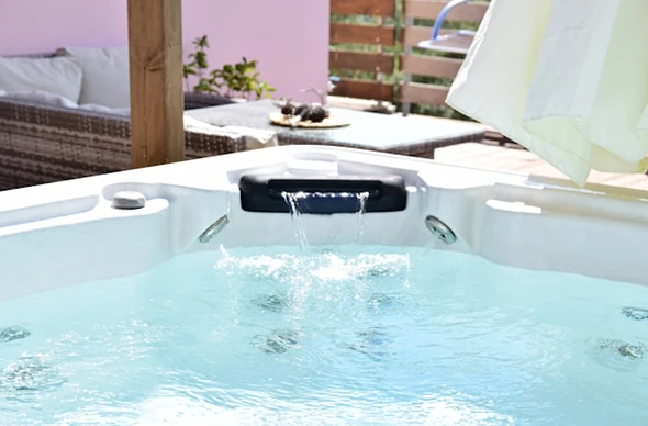 A bright, modern spa with clear water and jets.